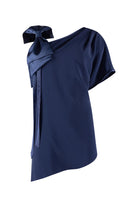 Navy blue one-shoulder top with a bow detail on a white background