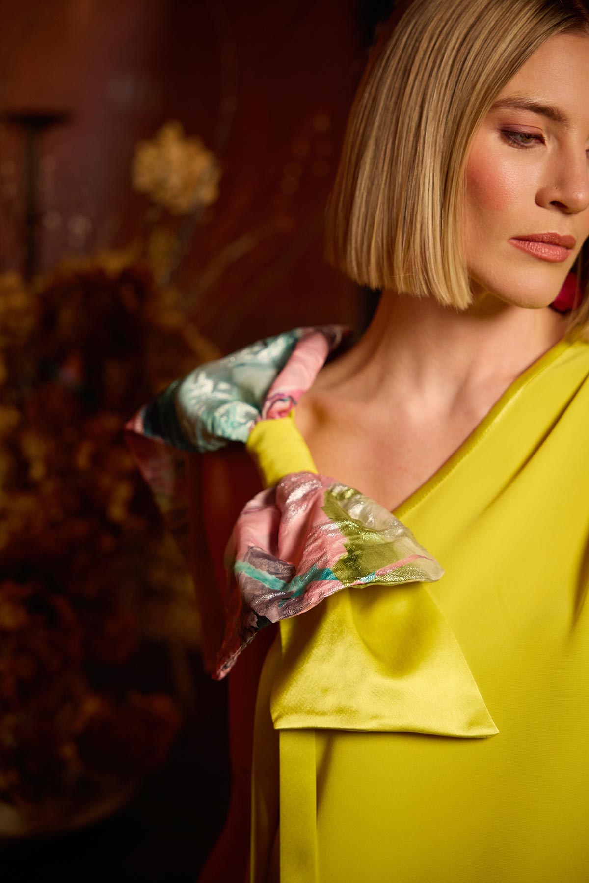 Woman wearing a colorful jacket with a blurred background