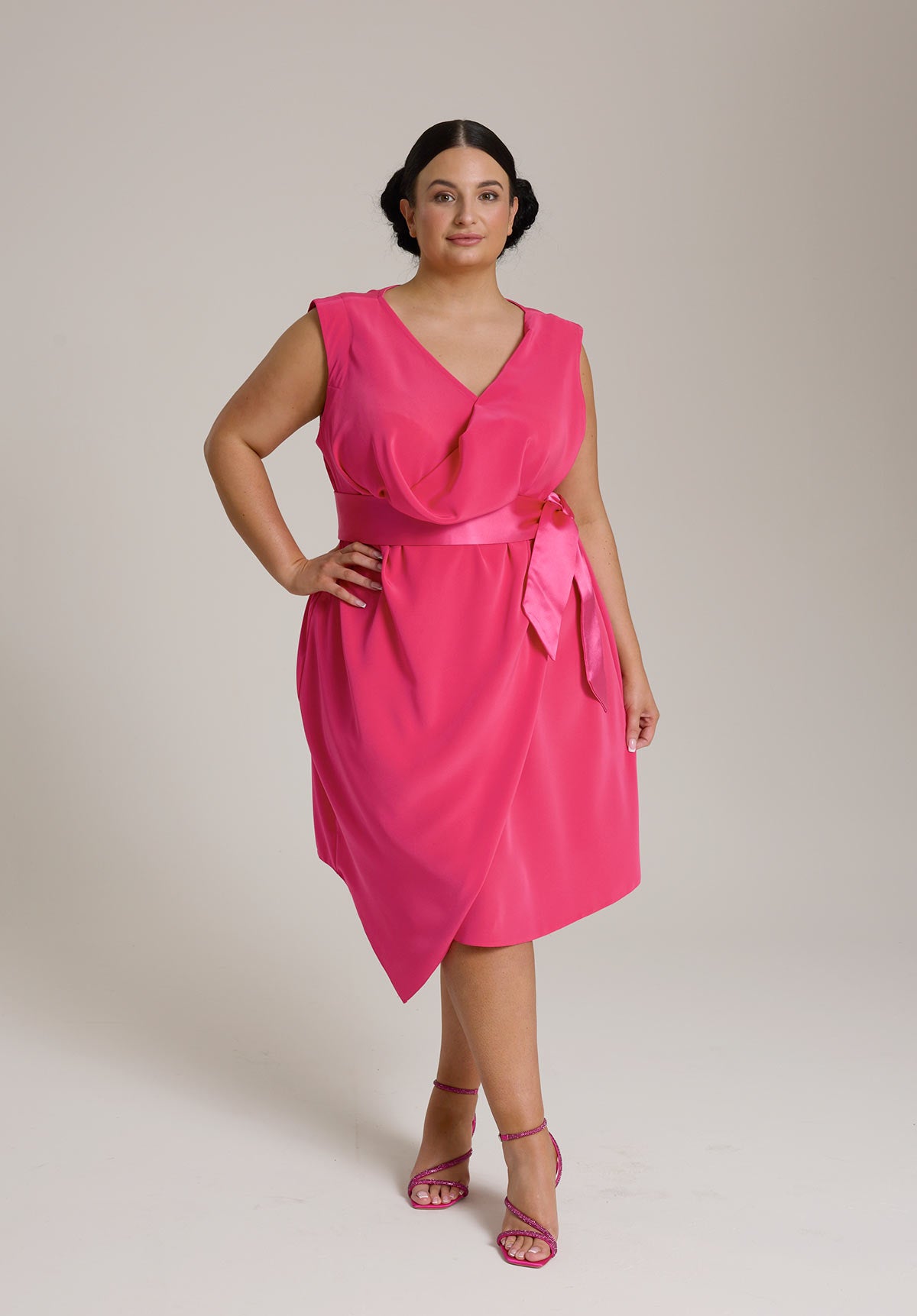 Monessa Joan pink Ailbhe dress with V-neckline and satin ribbon belt.