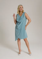 Monessa Joan sleeveless Ailbhe dress in teal colour with draped neckline and asymmetrical hemline.