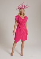 Monessa Joan pink Ailbhe Dress, paired with elaborate pink fascinator and heels.