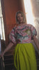 Videoof a Woman wearing a colorful blouse and duck egg pants.