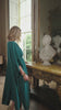 video of a woman wearing a teal dress