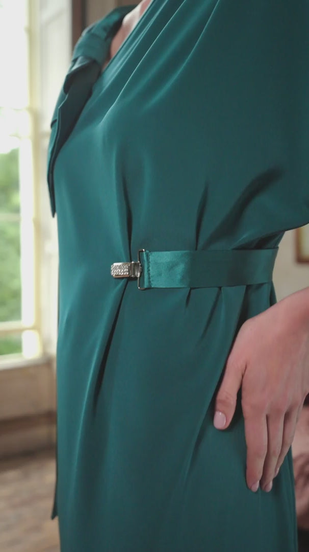 video of a woman wearing a teal dress with a belt