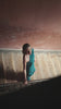 video of a woman in a teal dress on the staircase