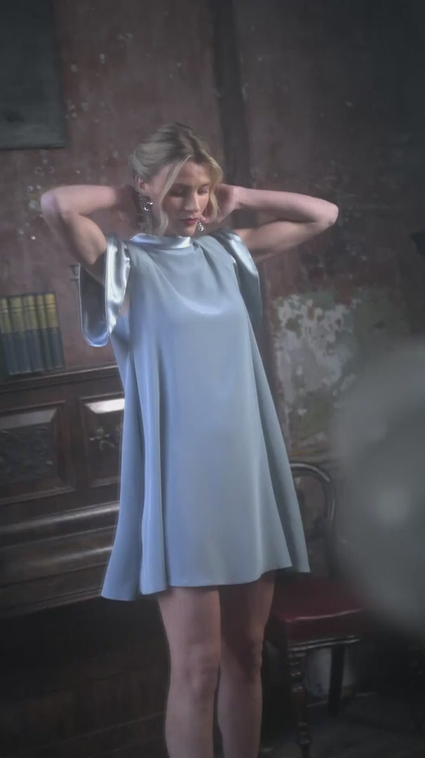 Video of a woman wearing duck egg coloured dress with short sleeves