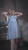 Video of a woman wearing duck egg coloured dress with short sleeves