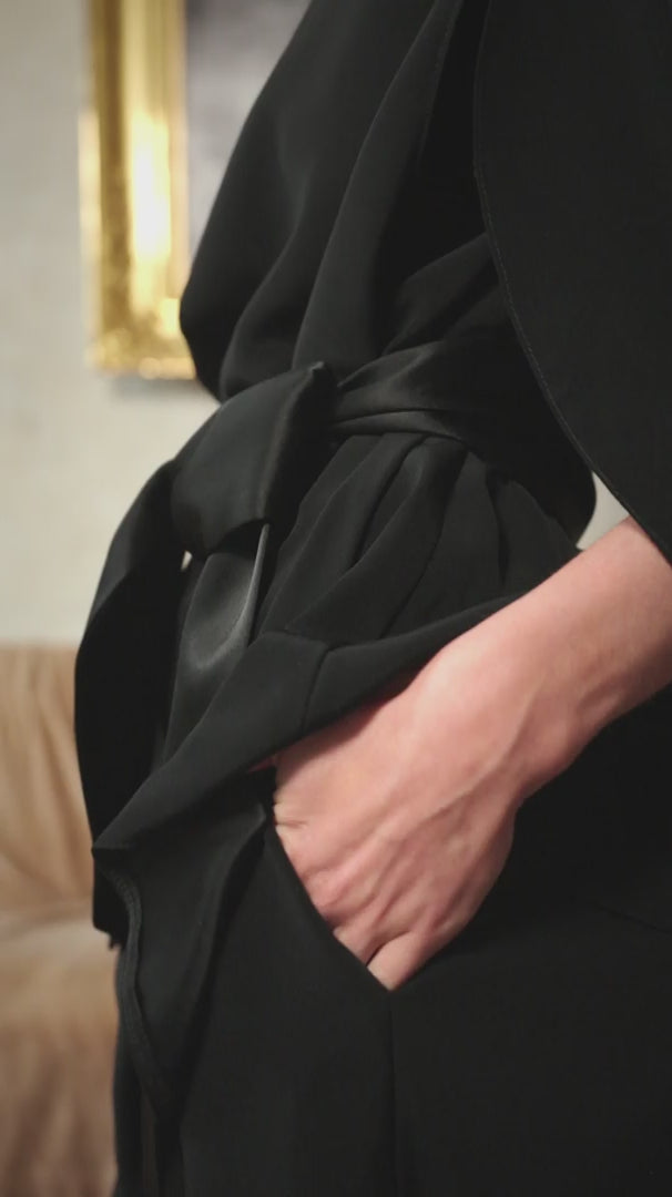 video of a woman wearing a black evening outfit