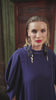 video of a blonde hair woman wearing navy bue dress and large gold earings