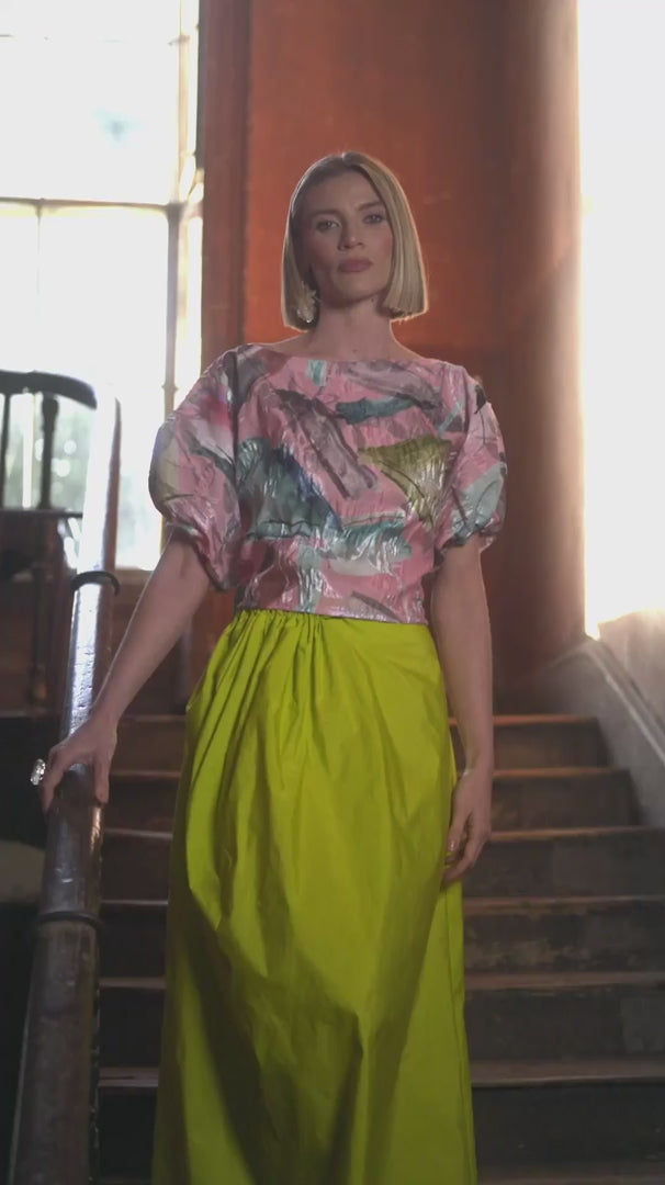 Woman wearing lime yellow skirt with colourful top