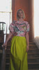 Woman wearing lime yellow skirt with colourful top