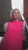 woman in a cerise dress with flower print short sleeves
