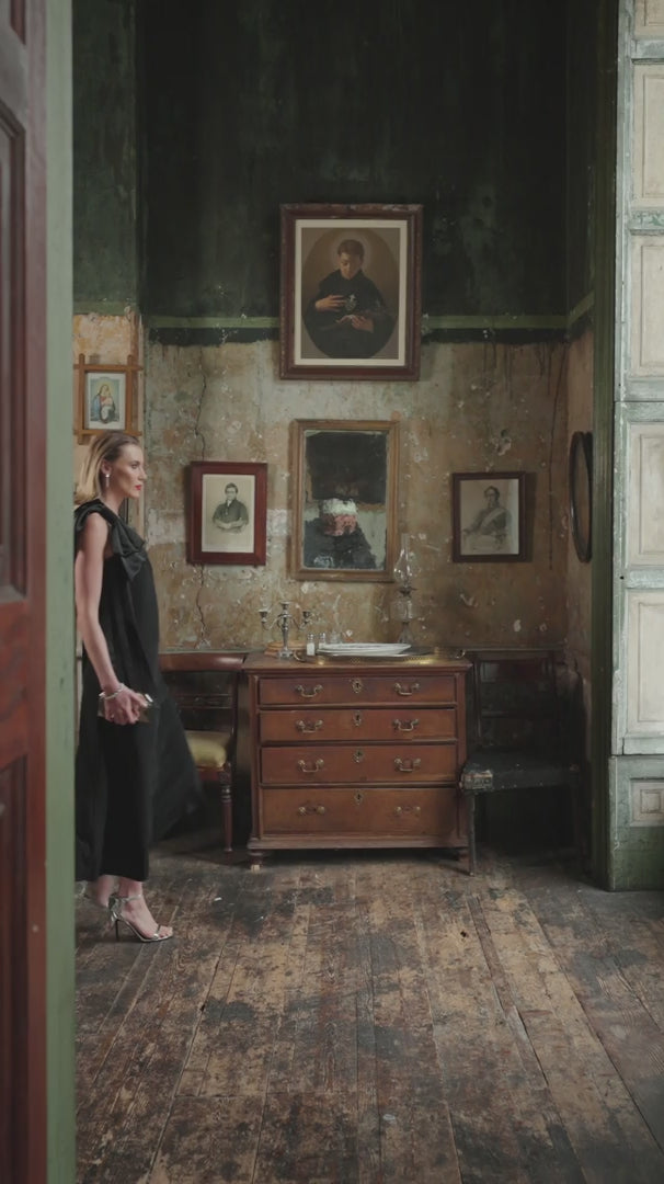 video of a woman wearing black dress with open shoulder