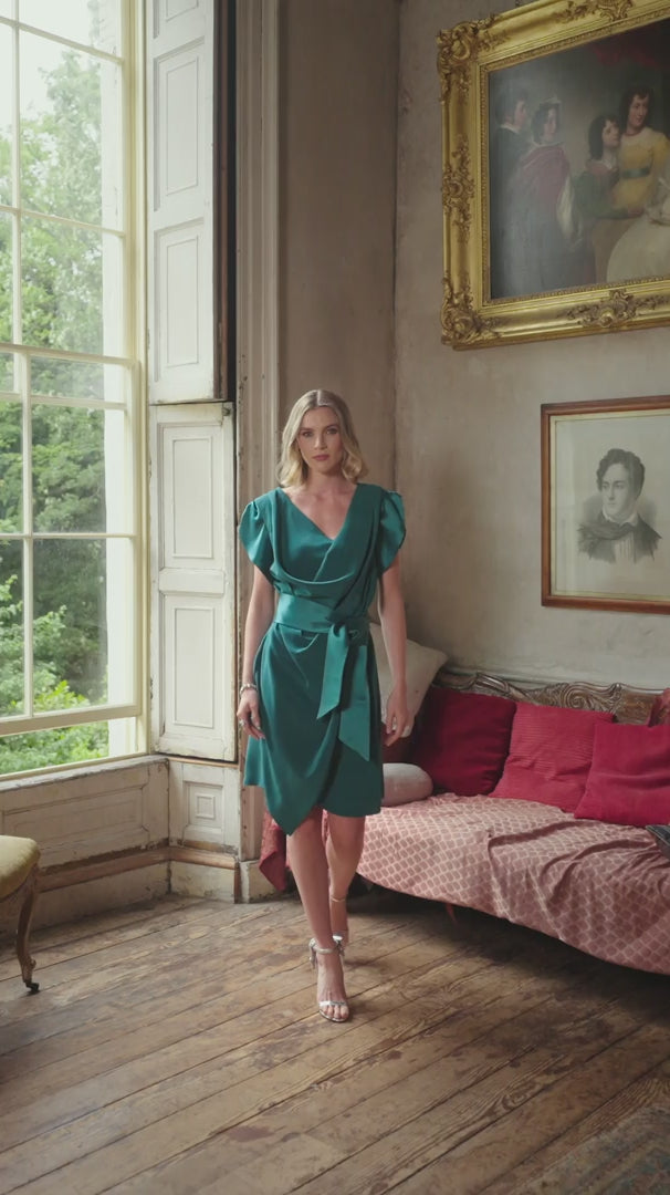 video of a woman wearing a short sleeve teal dress in a room with classic design