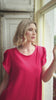 video of a woman wearing a red occasion dress
