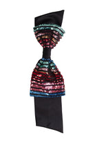 Colorful sequin bow against a white background